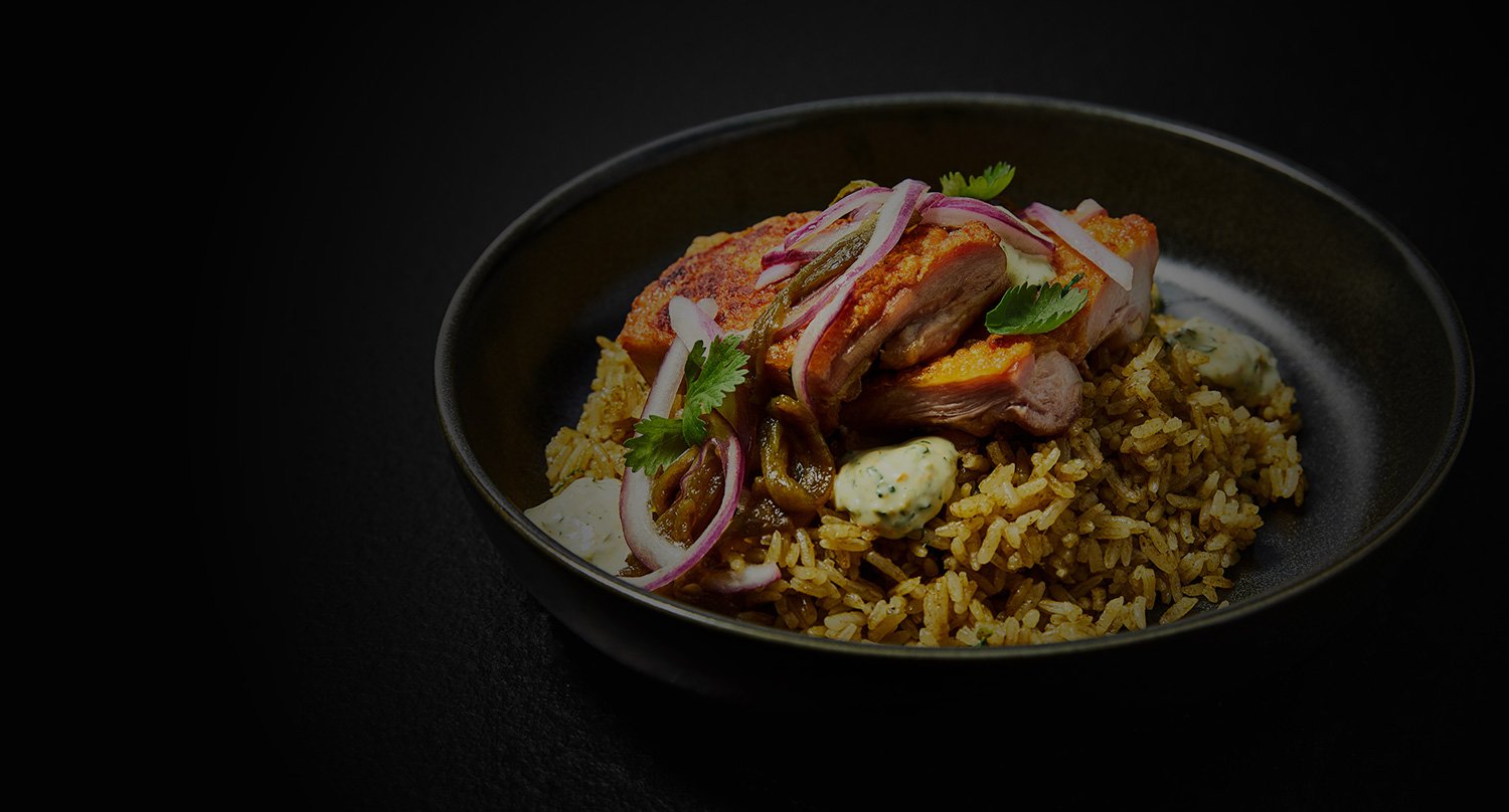 a bowl with rice and chicken